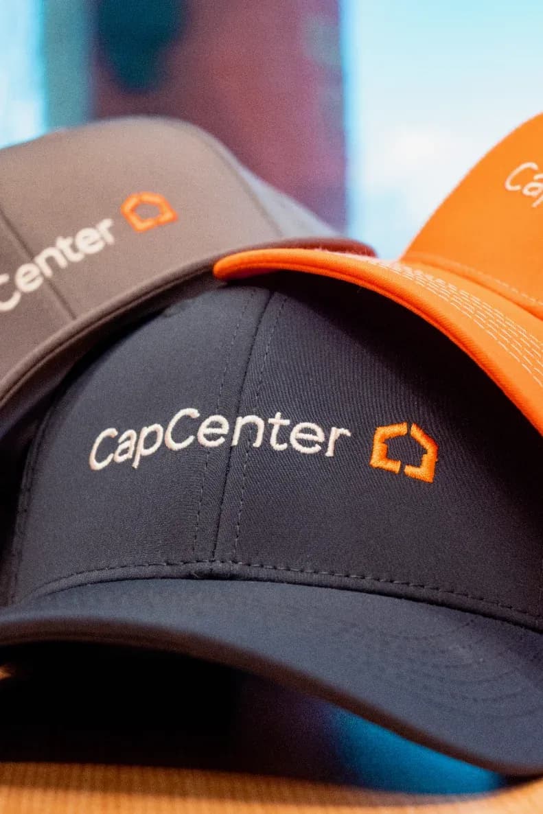 Embroidered CapCenter team caps in navy, grey and orange