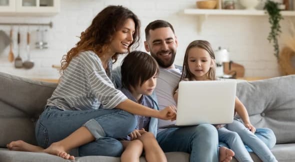 Family relaxing together on a couch at home